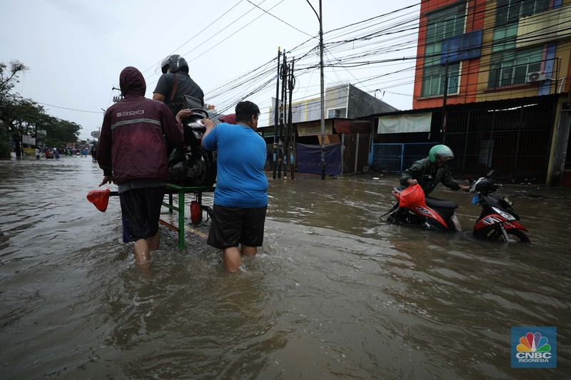 Pengendara sepeda motor menggunakan jasa gerobak saat melintasi banjir di Ciledug, Tangerang Banten, Sabtu (16/7/2022). (CNBC Indonesia/Tri Susilo) Pengendara sepeda motor menggunakan jasa gerobak saat melintasi banjir di Ciledug, Tangerang Banten, Sabtu (16/7/2022). (CNBC Indonesia/Tri Susilo)