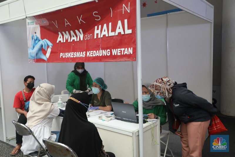 Pengunjung mall mengantri untuk melakukan vaksinasi dosis ketiga covid-19 di mall Bale Kota Tangerang, Banten, Selasa 19/07. Pemerintah resmi memberlakukan wajib vaksin booster atau dosis ketiga untuk masuk mal atau area publik lainnya. (CNBC Indonesia/Muhammad Sabki)