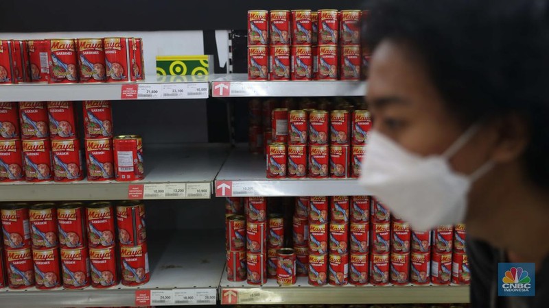 Pengunjung melintas di depan rak sarden di Supermarket, Jakarta, Kamis, 21/7. Harga olahan pangan satu per satu naik, selain mi instan salah satunya ikan kaleng olahan. (CNBC Indonesia/Muhammad Sabki)
