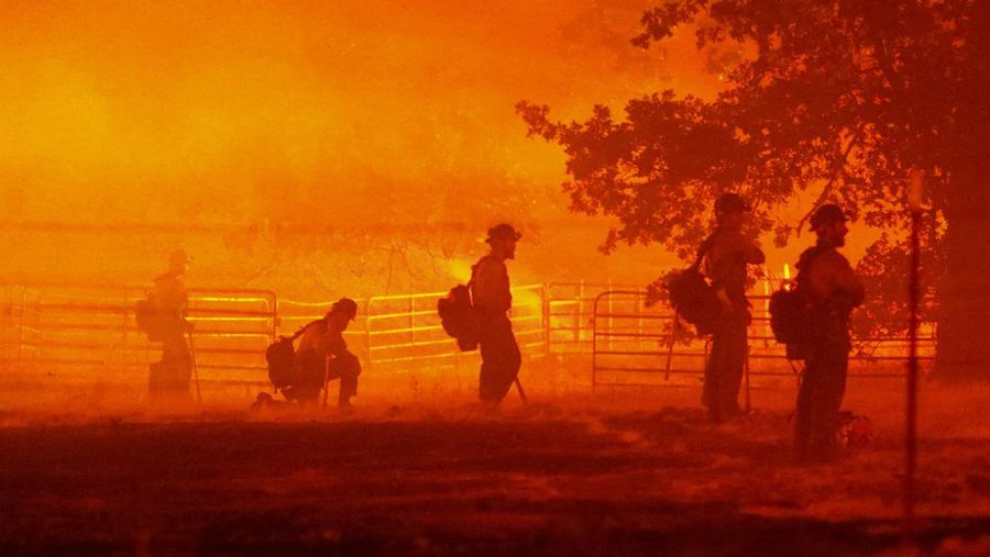 Firefighters look on as the Oak Fire burns in Darrah in Mariposa County, California, U.S. July 22, 2022. REUTERS/David Swanson TPX IMAGES OF THE DAY