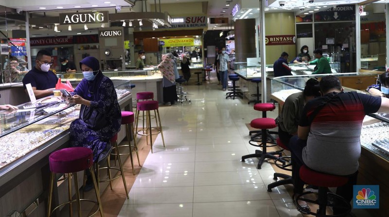 Pemilik toko perhiasan menata perhiasan emas di Kawasan Cikini Gold Center, Jakarta, Senin, (25/7/2022). (CNBC Indonesia/Muhammad Sabki)