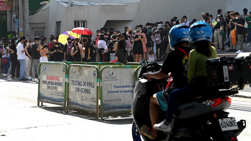 Warga menyelamatkan diri ke luar gedung setelah gempa berkekuatan 7,1 SR, sekitar 300 kilometer jauhnya, terasa di Manila pada 27 Juli 2022. (AFP via Getty Images/JAM STA ROSA)