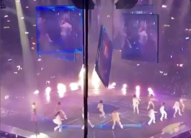 Hong Kong Concert Investigation In this image made from video taken from social media, a video screen suspended above the stage falls onto the stage where dancers perform at a concert of Cantopop boy band Mirror in Hong Kong, Thursday, July 28, 2022. Hong Kong officials say they will open an investigation into the concert accident in which the giant video screen fell down onto the stage and injured two dancers. (AP Photo)