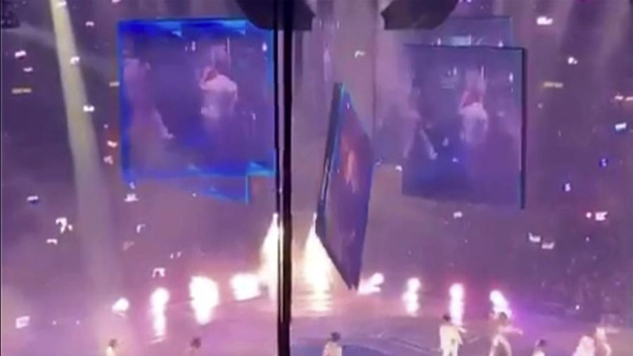 In this image made from video taken from social media, a video screen suspended above the stage falls onto the stage where dancers perform at a concert of Cantopop boy band Mirror in Hong Kong, Thursday, July 28, 2022. Hong Kong officials say they will open an investigation into the concert accident in which the giant video screen fell down onto the stage and injured two dancers. (AP Photo)