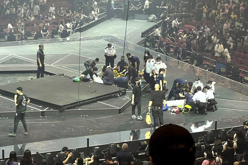 Hong Kong Concert Investigation In this image made from video taken from social media, a video screen suspended above the stage falls onto the stage where dancers perform at a concert of Cantopop boy band Mirror in Hong Kong, Thursday, July 28, 2022. Hong Kong officials say they will open an investigation into the concert accident in which the giant video screen fell down onto the stage and injured two dancers. (AP Photo)