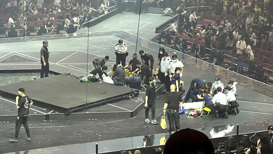 In this image made from video taken from social media, a video screen suspended above the stage falls onto the stage where dancers perform at a concert of Cantopop boy band Mirror in Hong Kong, Thursday, July 28, 2022. Hong Kong officials say they will open an investigation into the concert accident in which the giant video screen fell down onto the stage and injured two dancers. (AP Photo)