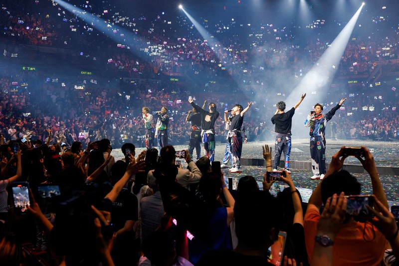 In this image made from video taken from social media, a video screen suspended above the stage falls onto the stage where dancers perform at a concert of Cantopop boy band Mirror in Hong Kong, Thursday, July 28, 2022. Hong Kong officials say they will open an investigation into the concert accident in which the giant video screen fell down onto the stage and injured two dancers. (AP Photo)