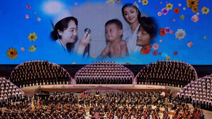 142973408 Images are displayed on a screen as North Korean performers sing at a theatre during celebrations to mark the 100th birth anniversary of the country's founding leader Kim Il-Sung, in Pyongyang on April 16, 2012. The commemorations came just three days after a satellite launch timed to mark the centenary fizzled out embarrassingly when the rocket apparently exploded within minutes of blastoff and plunged into the sea. AFP PHOTO / Ed Jones (Photo credit should read Ed Jones/AFP via Getty Images)