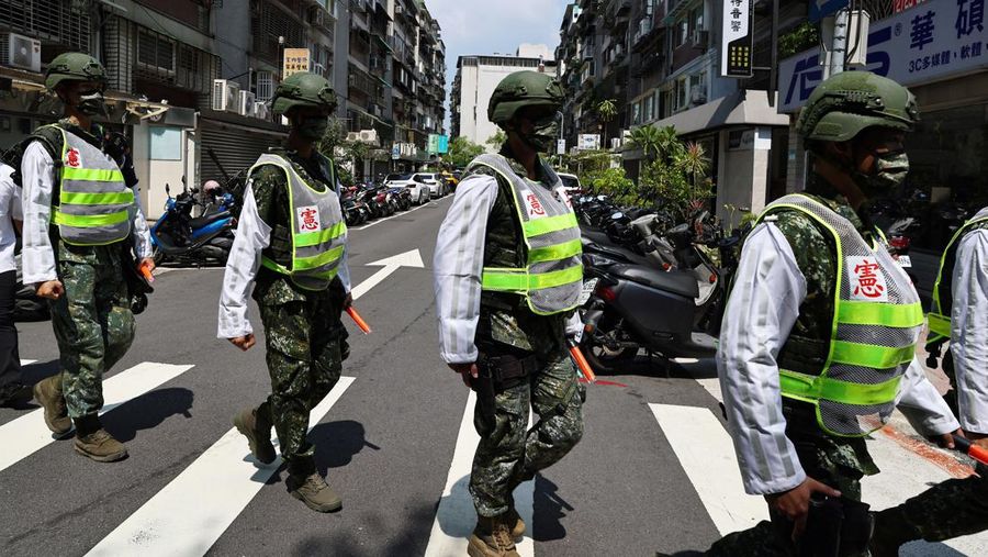 Military police officers get into position for a drill on how to guide citizens to safety in the event of an attack, in Taipei, Taiwan July 22, 2022. REUTERS/Ann Wang
