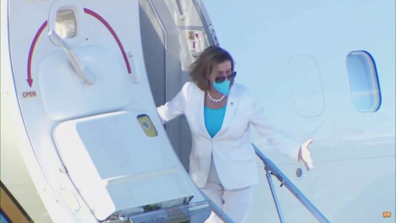 ASIA-PELOSI/ U.S. House of Representatives Speaker Nancy Pelosi waves with other members of the delegation as they board a plane before leaving Taipei Songshan Airport, in Taipei, Taiwan August 3, 2022, in this screengrab taken from video. REUTERS TV/Pool via REUTERS. NO RESALES. NO ARCHIVES.