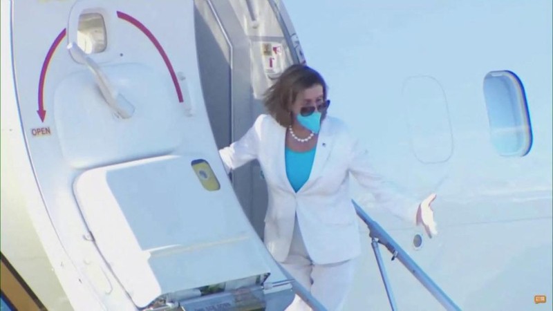 U.S. House of Representatives Speaker Nancy Pelosi waves with other members of the delegation as they board a plane before leaving Taipei Songshan Airport, in Taipei, Taiwan August 3, 2022, in this screengrab taken from video. REUTERS TV/Pool via REUTERS. NO RESALES. NO ARCHIVES.