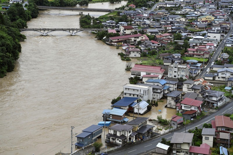 An aerial view shows debris and destroyed houses, caused by a flash flood due to heavy rains, in Murakami, Niigata prefecture, Japan August 4, 2022, in this photo taken by Kyodo. Mandatory credit Kyodo via REUTERS ATTENTION EDITORS - THIS IMAGE WAS PROVIDED BY A THIRD PARTY. MANDATORY CREDIT. JAPAN OUT. NO COMMERCIAL OR EDITORIAL SALES IN JAPAN