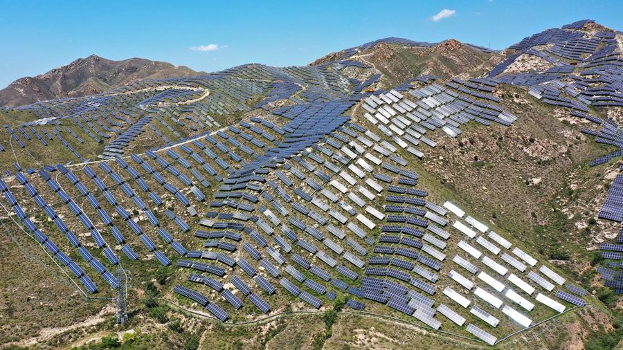 ZHANGJIAKOU, CHINA - AUGUST 6, 2022 - An aerial photo shows a photovoltaic power station on barren mountain in Zhangjiakou, Hebei province, Aug 6, 2022. (Photo credit should read CFOTO/Future Publishing via Getty Images)