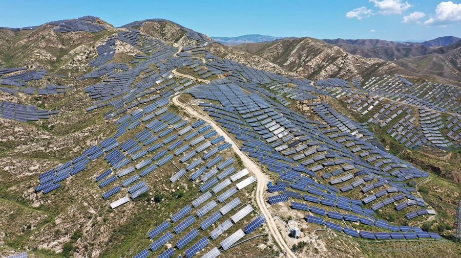 ZHANGJIAKOU, CHINA - AUGUST 6, 2022 - An aerial photo shows a photovoltaic power station on barren mountain in Zhangjiakou, Hebei province, Aug 6, 2022. (Photo credit should read CFOTO/Future Publishing via Getty Images)