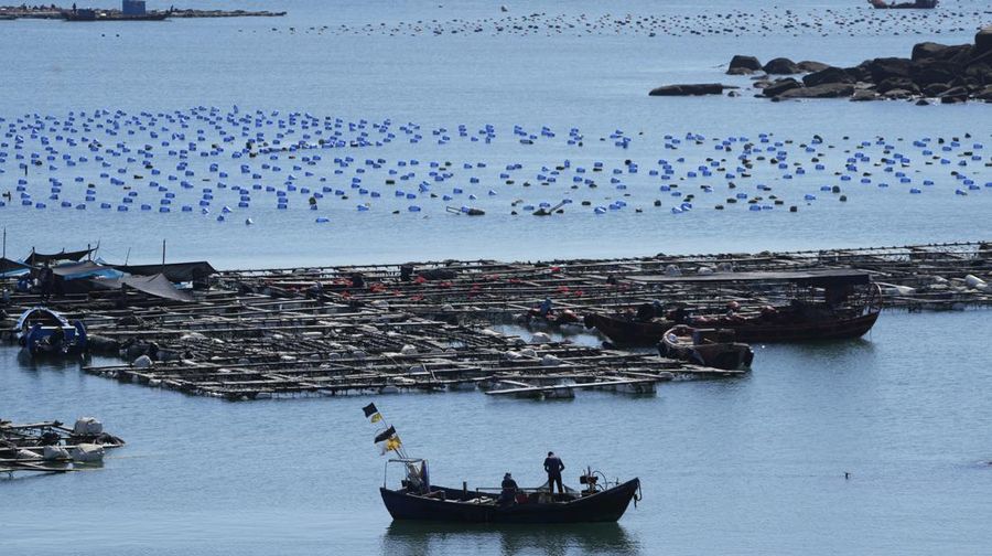 A boat moves through the water at the 68-nautical-mile scenic spot, the closest point in mainland China to the island of Taiwan, in Pingtan in southeastern China's Fujian Province, Friday, Aug. 5, 2022. China conducted 