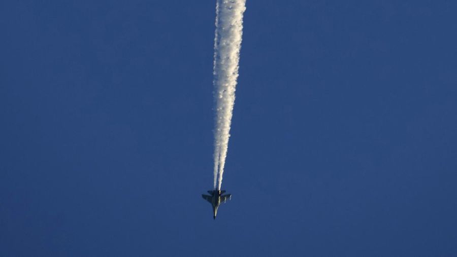A military jet fighter flies above the Taiwan Strait as seen from the 68-nautical-mile scenic spot, the closest point in mainland China to the island of Taiwan, in Pingtan in southeastern China's Fujian Province, Friday, Aug. 5, 2022. China says it is canceling or suspending dialogue with the U.S. on issues from climate change to military relations and anti-drug efforts in retaliation for a visit this week to Taiwan by U.S. House Speaker Nancy Pelosi. (AP Photo/Ng Han Guan)