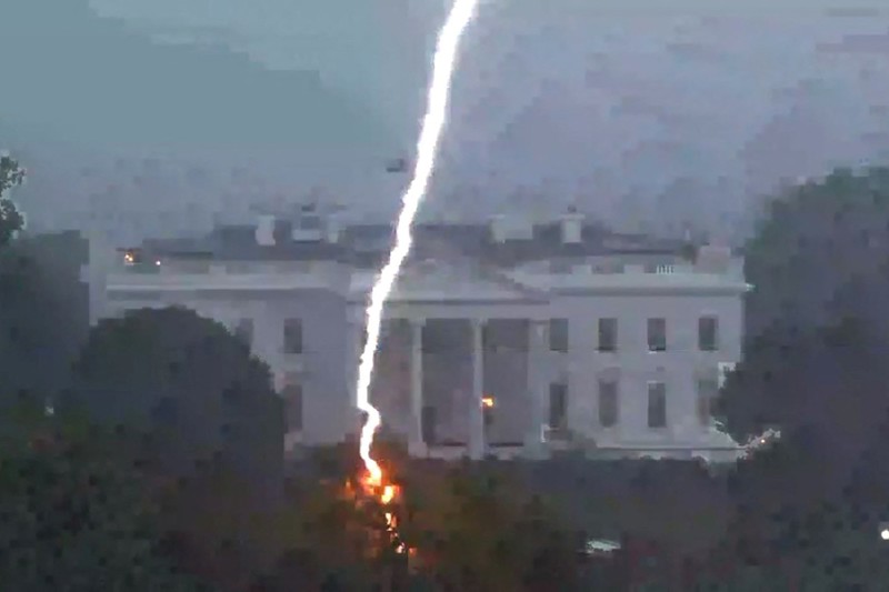 USA-LIGHTNING/ A lightning strike hits a tree in Lafayette Park across from the White House, killing two people and injuring two others below, during an August 4 evening thunderstom as seen in this framegrab from a Reuters TV video camera mounted on a nearby rooftop in Washington, U.S. August 4, 2022. REUTERS/REUTERS TV