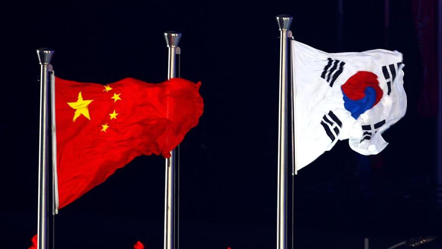 GUANGZHOU, CHINA - NOVEMBER 27:  The flags of China and South Korea are displayed side-by-side during the Closing Ceremony at Haixinsha Square on day fifteen of the 16th Asian Games Guangzhou 2010 on November 27, 2010 in Guangzhou, China. Incheon, South Korea will be the host of the next Asian Games in 2014.  (Photo by Feng Li/Getty Images)