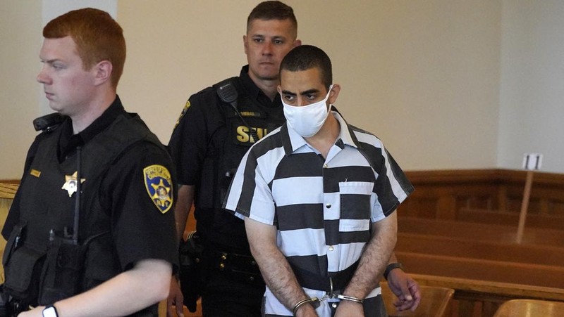 Hadi Matar (24) tengah, tiba untuk dakwaan di Gedung Pengadilan Chautauqua County di Mayville, NY, Sabtu (13/8/2022).. Matar, yang dituduh melakukan serangan penikaman terhadap penulis “Satanic Verses” Salman Rushdie telah masuk pembelaan tidak bersalah di pengadilan New York atas tuduhan percobaan pembunuhan dan penyerangan. (AP Photo/Gene J. Puskar)