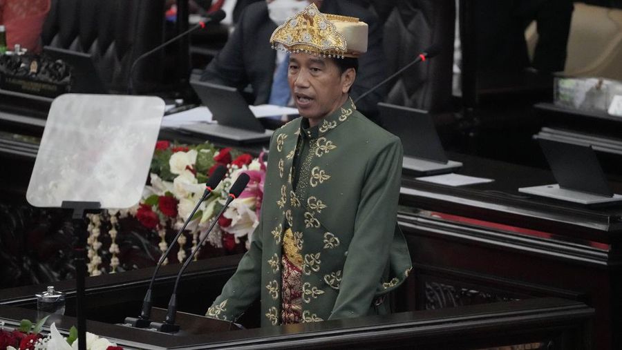 Indonesian President Joko Widodo, wearing traditional Bangka Belitung outfit, gestures as he delivers his annual State of the Nation Address ahead of the country's Independence Day, at the parliament building in Jakarta, Indonesia, Tuesday, Aug. 16, 2022. (AP Photo/Tatan Syuflana, Pool)