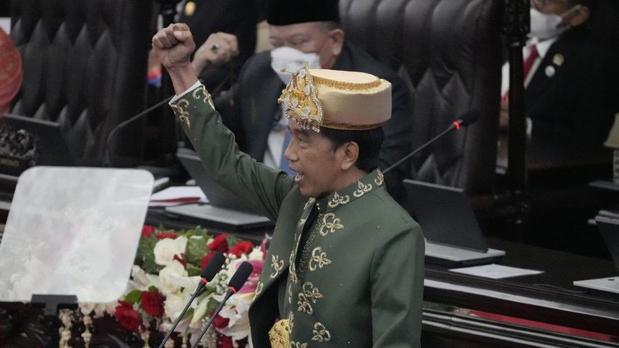 Indonesian President Joko Widodo, wearing traditional Bangka Belitung outfit, gestures as he delivers his annual State of the Nation Address ahead of the country's Independence Day, at the parliament building in Jakarta, Indonesia, Tuesday, Aug. 16, 2022. (AP Photo/Tatan Syuflana, Pool)