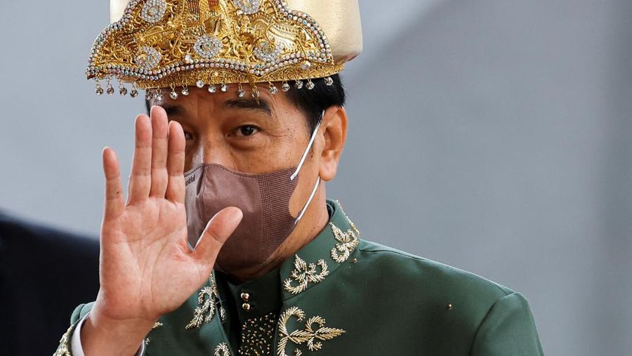 Presiden Indonesia Joko Widodo, mengenakan pakaian adat dari Kepulauan Bangka Belitung, melambai kepada wartawan saat meninggalkan gedung parlemen setelah menyampaikan kenegaraan tahunan, menjelang Hari Kemerdekaan negara, di Jakarta, Selasa (16/8/2022). (REUTERS/Willy Kurniawan)