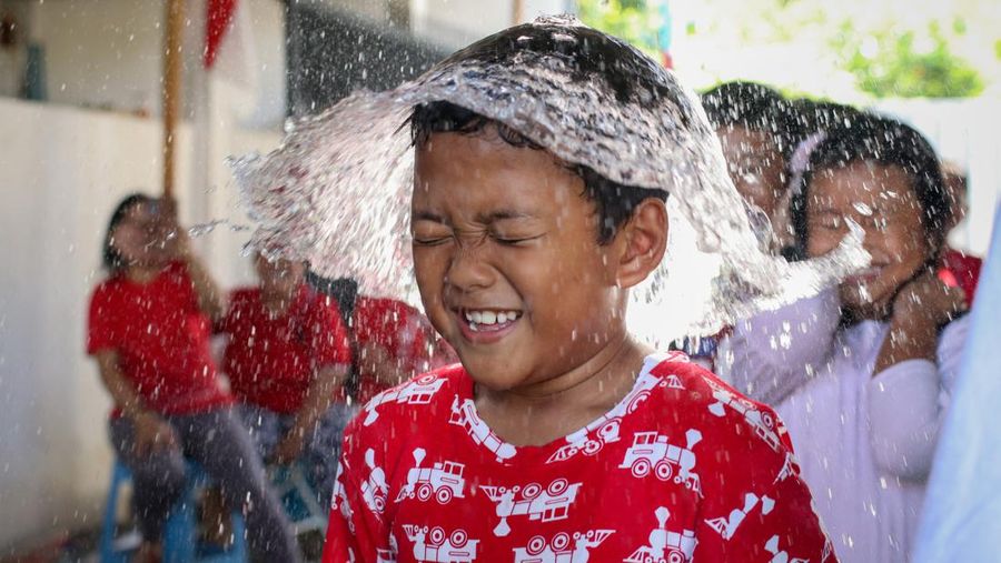 Children take part in games held to celebrate the 77th Independence Day of the Republic of Indonesia, in Surabaya on August 17, 2022. (Photo by JUNI KRISWANTO / AFP) (Photo by JUNI KRISWANTO/AFP via Getty Images)