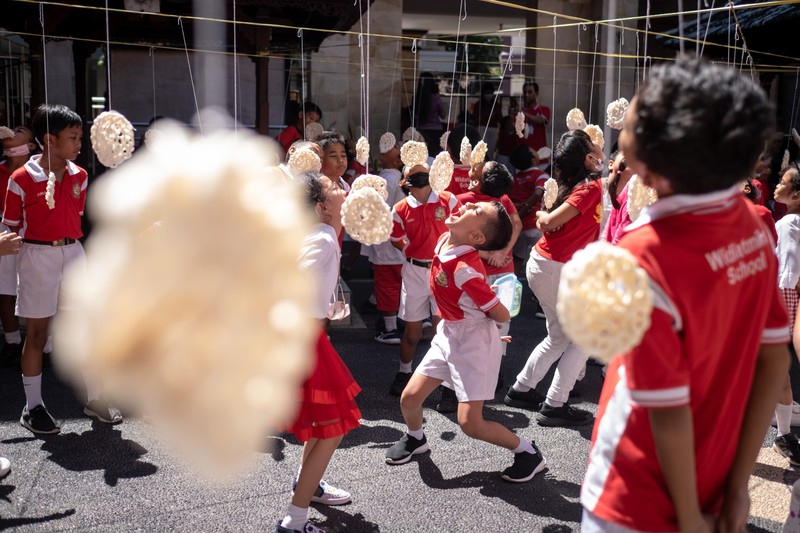 Children take part in games held to celebrate the 77th Independence Day of the Republic of Indonesia, in Surabaya on August 17, 2022. (Photo by JUNI KRISWANTO / AFP) (Photo by JUNI KRISWANTO/AFP via Getty Images)