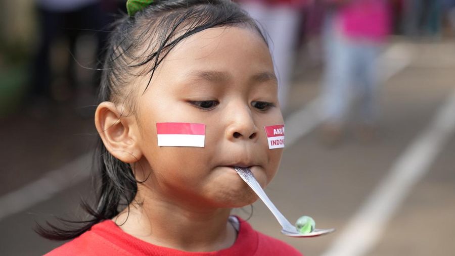 A child takes part in a spoon race during an Independence Day celebration in Jakarta, Wednesday, Aug 17, 2022. Indonesia is celebrating its 77th anniversary of independence from the Dutch colonial rule. (AP Photo/Achmad Ibrahim)