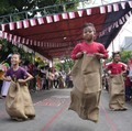 Children take part in a sack race competition during an Independence Day celebration in Jakarta, Wednesday, Aug. 17, 2022. Indonesia is celebrating its 77th anniversary of independence from the Dutch colonial rule. (AP Photo/Achmad Ibrahim)