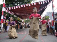 Children take part in a sack race competition during an Independence Day celebration in Jakarta, Wednesday, Aug. 17, 2022. Indonesia is celebrating its 77th anniversary of independence from the Dutch colonial rule. (AP Photo/Achmad Ibrahim)