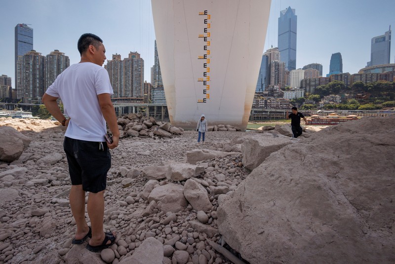 The central pillar of Qiansimen bridge stands exposed on the dried-up riverbed of the Jialing river, a tributary of the Yangtze, that is approaching record-low water levels in Chongqing, China, August 18, 2022.   REUTERS/Thomas Peter