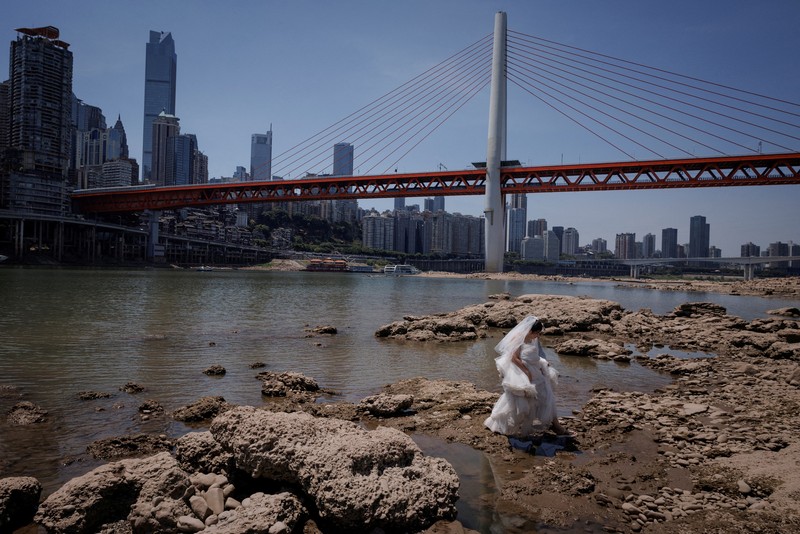 CHINA-WEATHER/ The central pillar of Qiansimen bridge stands exposed on the dried-up riverbed of the Jialing river, a tributary of the Yangtze, that is approaching record-low water levels in Chongqing, China, August 18, 2022. REUTERS/Thomas Peter