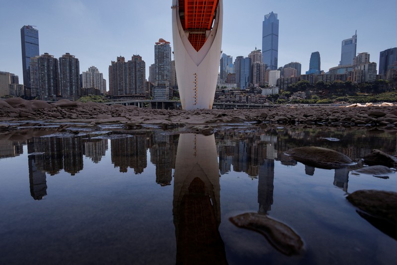 The central pillar of Qiansimen bridge stands exposed on the dried-up riverbed of the Jialing river, a tributary of the Yangtze, that is approaching record-low water levels in Chongqing, China, August 18, 2022.   REUTERS/Thomas Peter