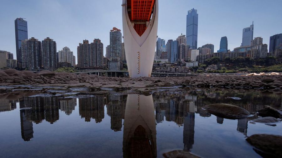 The central pillar of Qiansimen bridge stands exposed on the dried-up riverbed of the Jialing river, a tributary of the Yangtze, that is approaching record-low water levels in Chongqing, China, August 18, 2022.   REUTERS/Thomas Peter