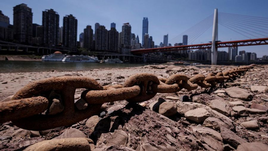 The central pillar of Qiansimen bridge stands exposed on the dried-up riverbed of the Jialing river, a tributary of the Yangtze, that is approaching record-low water levels in Chongqing, China, August 18, 2022.   REUTERS/Thomas Peter