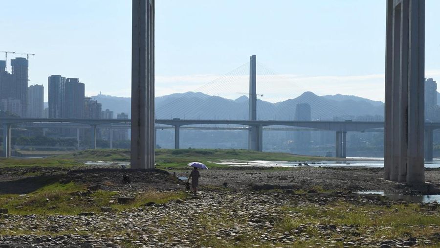 The central pillar of Qiansimen bridge stands exposed on the dried-up riverbed of the Jialing river, a tributary of the Yangtze, that is approaching record-low water levels in Chongqing, China, August 18, 2022.   REUTERS/Thomas Peter
