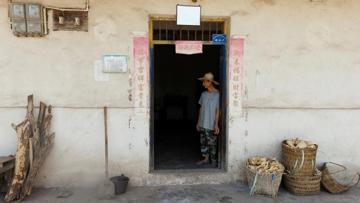 Local farmer Chen Xiaohua, 68, stands in his house where the water has been turned off as the region is experiencing a drought in Fuyuan village in Chongqing, China, August 19, 2022.  REUTERS/Thomas Peter