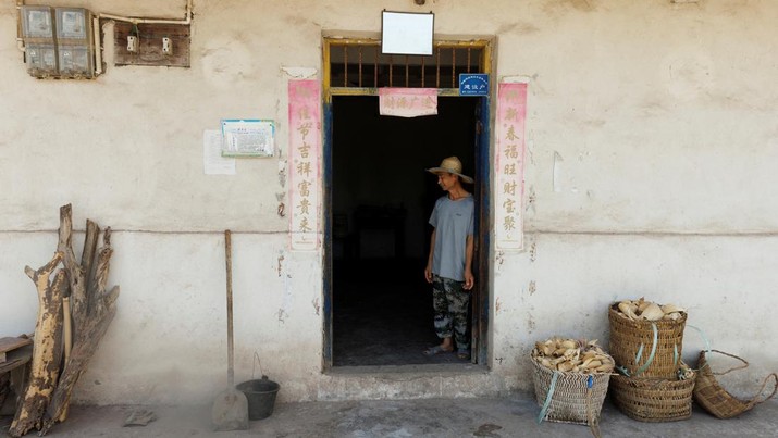 CHINA-WEATHER/FARMER Local farmer Chen Xiaohua, 68, stands in his house where the water has been turned off as the region is experiencing a drought in Fuyuan village in Chongqing, China, August 19, 2022. REUTERS/Thomas Peter