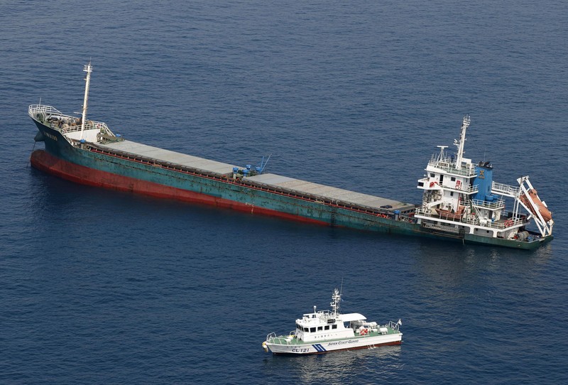 Japan Ship Collision This aerial photo shows Belize-registered cargo ship Xin Hai 99, after a collision, off Kushimoto, Wakayama prefecture, southwestern Japan, Saturday, Aug. 20, 2022. A Japanese chemical tanker ship crashed into the cargo ship off the coast of southwestern Japan, the coast guard said Saturday.(Kyodo News via AP)