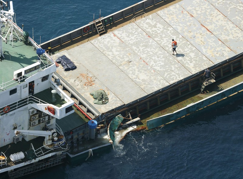 Japan Ship Collision This aerial photo shows Belize-registered cargo ship Xin Hai 99, after a collision, off Kushimoto, Wakayama prefecture, southwestern Japan, Saturday, Aug. 20, 2022. A Japanese chemical tanker ship crashed into the cargo ship off the coast of southwestern Japan, the coast guard said Saturday.(Kyodo News via AP)