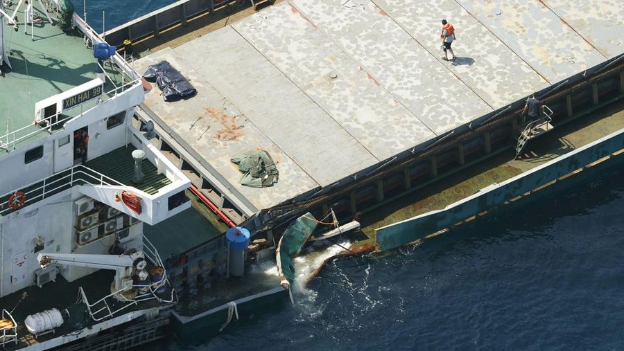This aerial photo shows Belize-registered cargo ship Xin Hai 99, after a collision, off Kushimoto, Wakayama prefecture, southwestern Japan, Saturday, Aug. 20, 2022. A Japanese chemical tanker ship crashed into the cargo ship off the coast of southwestern Japan, the coast guard said Saturday.(Kyodo News via AP)