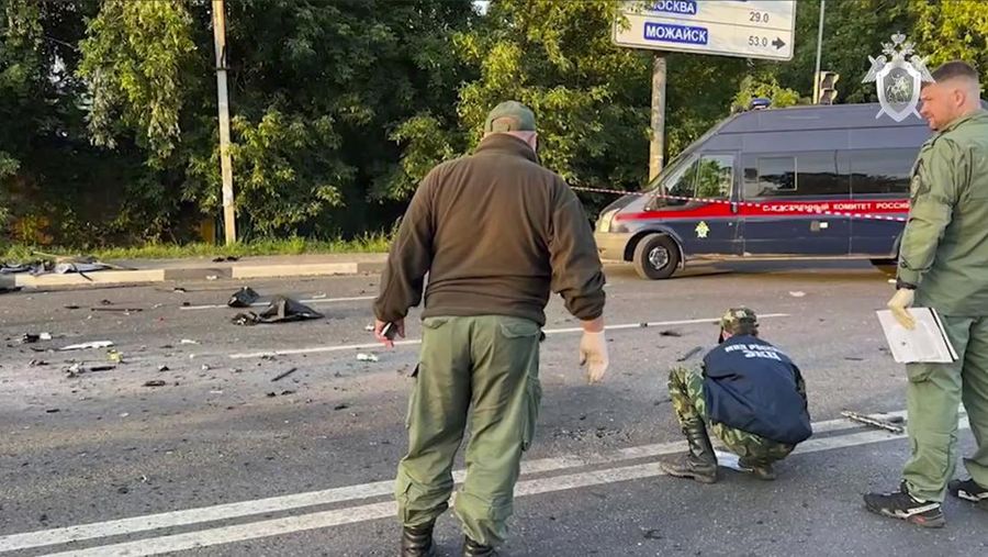 In this handout photo taken from video released by Investigative Committee of Russia on Sunday, Aug. 21, 2022, investigators work on the site of explosion of a car driven by Daria Dugina outside Moscow. Daria Dugina, the daughter of Alexander Dugin, the Russian nationalist ideologist often called 