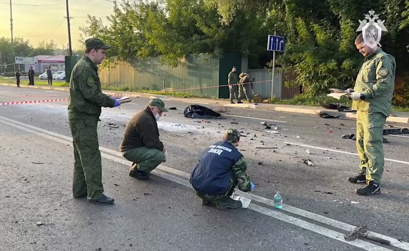 In this handout photo taken from video released by Investigative Committee of Russia on Sunday, Aug. 21, 2022, investigators work on the site of explosion of a car driven by Daria Dugina outside Moscow. Daria Dugina, the daughter of Alexander Dugin, the Russian nationalist ideologist often called 