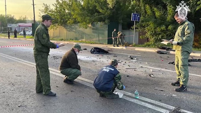 In this handout photo taken from video released by Investigative Committee of Russia on Sunday, Aug. 21, 2022, investigators work on the site of explosion of a car driven by Daria Dugina outside Moscow. Daria Dugina, the daughter of Alexander Dugin, the Russian nationalist ideologist often called 