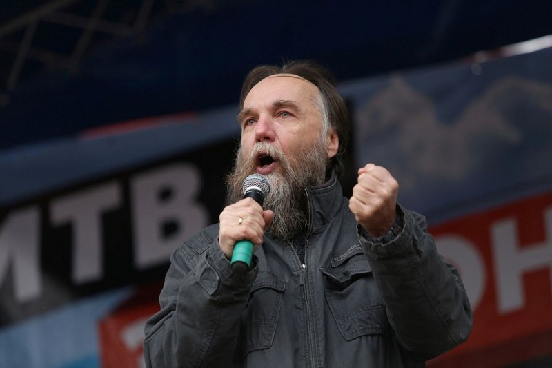 In this handout photo taken from video released by Investigative Committee of Russia on Sunday, Aug. 21, 2022, investigators work on the site of explosion of a car driven by Daria Dugina outside Moscow. Daria Dugina, the daughter of Alexander Dugin, the Russian nationalist ideologist often called 