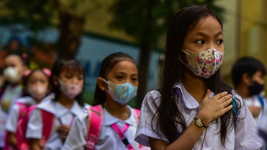 Students attend a flag-raising ceremony before singing the national anthem on the first day of in-person classes after years-long Covid-19 lockdowns at Pedro Guevara Elementary School in Manila on August 22, 2022. (Photo by Maria Tan / AFP) (Photo by MARIA TAN/AFP via Getty Images)