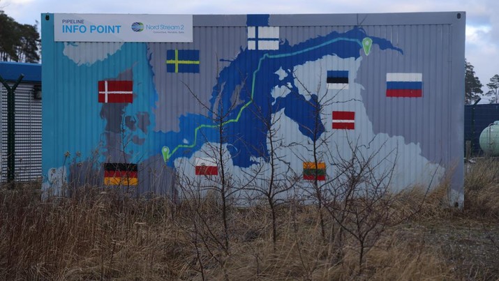 1368238914 LUBMIN, GERMANY - FEBRUARY 02: A map shows the course of the Nord Stream 2 gas pipeline from Russia to Germany on the exterior of an informational booth close to the receiving station for Nord Stream 2 on February 02, 2022 near Lubmin, Germany. Nord Stream 2, which is owned by Russian energy company Gazprom, is to transport Russian natural gas from Russia to Germany along over 1,200km of twin pipeline stretching across the bottom of the Baltic Sea. While Nord Stream 2 was completed in September of 2021, operation has been held up by German regulators. Most recently both German and EU officials have raised the possibility of halting Nord Stream 2 due to the build-up of Russian military forces on the border to Ukraine. The build-up has stoked international fears of an imminent military invasion. (Photo by Sean Gallup/Getty Images)