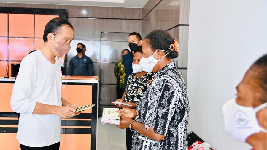 Presiden Joko Widodo didampingi Ibu Iriana Joko Widodo menyerahkan bantuan langsung tunai (BLT) bahan bakar minyak (BBM) untuk pertama kalinya di Kantor Pos Cabang Sentani, Kabupaten Jayapura, pada Rabu, 31 Agustus 2022. (Dok: Biro Pers Sekretariat Presiden)