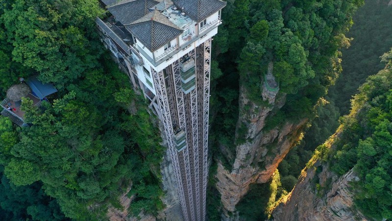 Aerial view of the Bailong Elevator built on a cliff in Zhangjiajie in south China's Hunan province Friday, July 26, 2019. The three glass elevators are 335 meters tall, and take tourists 326 m upward with 172 m on the vertical cliff and 154 m inside the mountain. It was claimed to be the tallest outdoor elevator in the world whn opened to the public by 2002. (Photo credit should read FANG DONGXU/Future Publishing via Getty Images)
